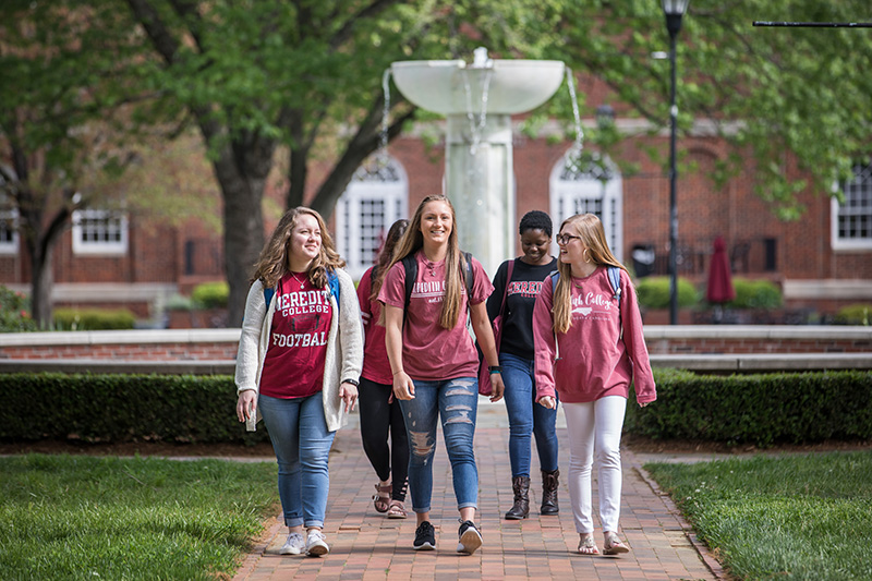 a group of students walking on campus