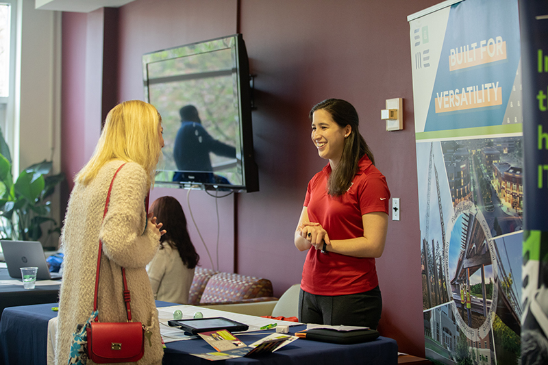 Two people at campus career fair talking