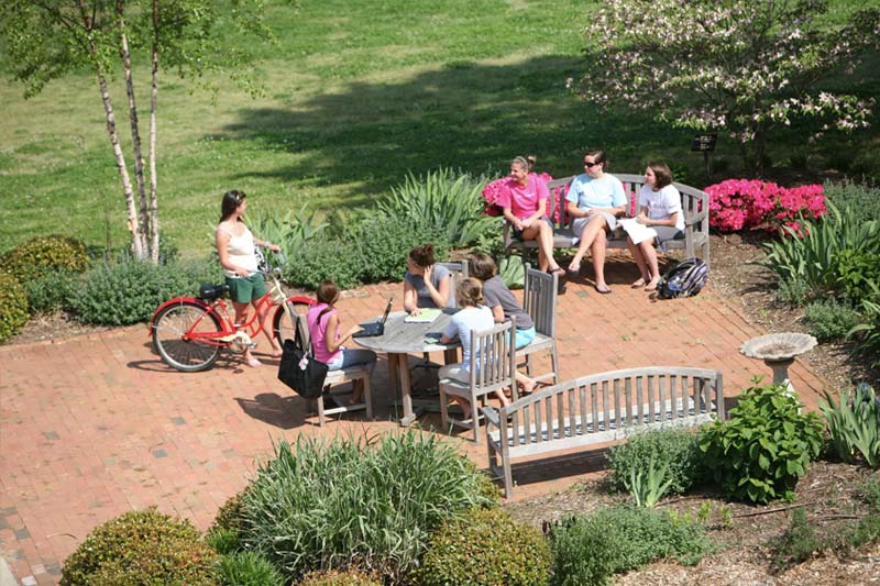 Students hanging out in a courtyard area outside of Heilman dorm.