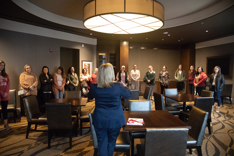 Students from hospitality management pay attention during a tour of the State View Hotel.