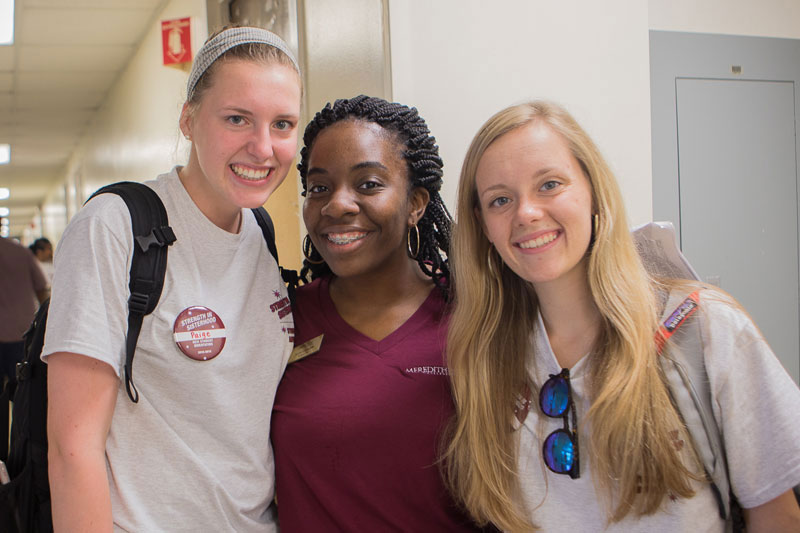 three students in residence hall