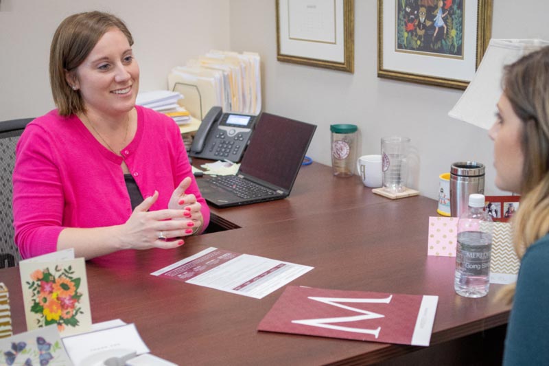 An admissions counselor talks with a student.