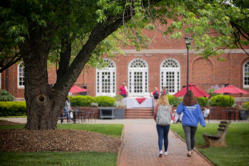 Two students walking towards the dining hall.