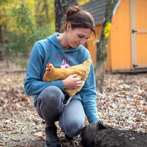 Alesja holding a hen.