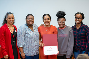 Five people pose with an award at datafest.