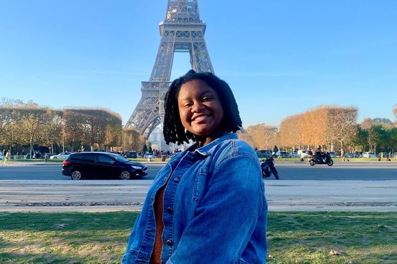 Meredith student abroad in France at Eiffel Tower.