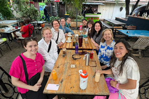 Meredith students at a table after a meal in Kenya