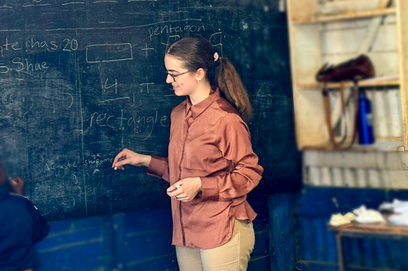 Student at chalkboard in Kenyan classroom