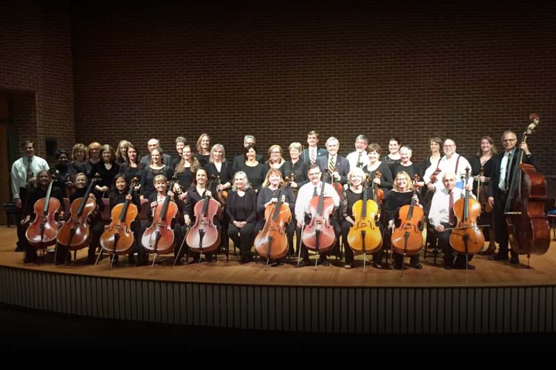 Triangle String Orchestra Musicians on stage with instruments.