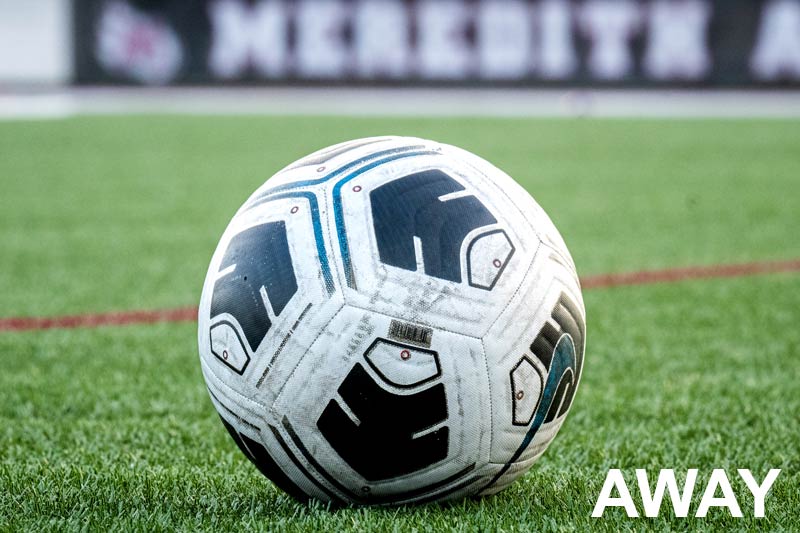 Soccer ball on field with AWAY written in corner.